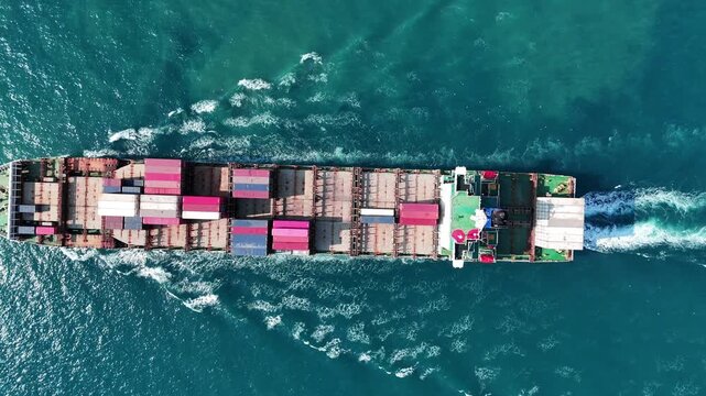 cargo container ship fully loaded with pink and red containers, assisted by a tugboat in the turquoise ocean. Global maritime logistics and supply chain concept.	international trade, and heavy ship