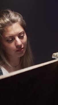 Portrait of talented woman drawing with spatula in artist's studio