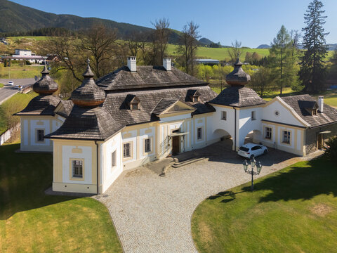 Aerial view of the historic Kastiel Kubinyi manor house with traditional shingle roofs and elegant architecture surrounded by green lawns Vysny Kubin, Zilinsky kraj, Slovakia.