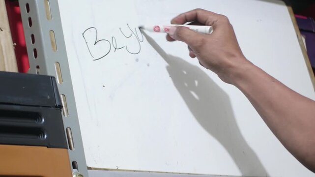 close up of hand writing be yourself on white board