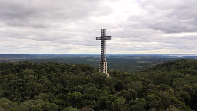 The prominent cross structure rising above the lush forest in Parque Tem&aacute;tico de la Cruz, Argentina. Ideal for travel and cultural documentaries.