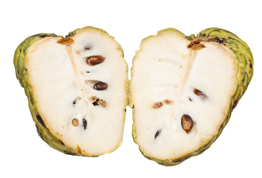 Custard apple cut in half, revealing soft flesh and seeds