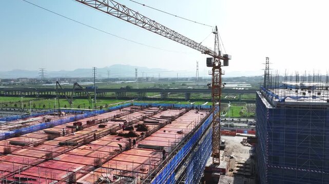 Construction site with tower crane and building foundation under construction work