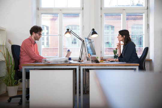 Man and woman working in office