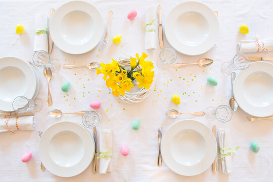 Laid Easter table with bunch of daffodils