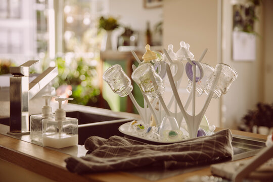 Collection of sterilized baby milk bottles in kitchen at home
