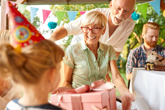Happy extended family on a garden birthday party