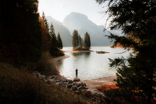 Hiker at Lago del Predil in autumn, Tarvisio, Julian Alps, Friuli-Venezia Giulia, Italy