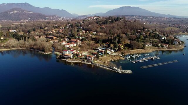Aerial view of Sasso Moro harbor and Leggiuno lakeside village on Lake Maggiore, province of Varese, Lombardy, Italy