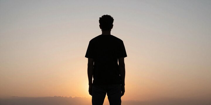 Silhouette of a man gazing at the sunset in a peaceful and reflective moment
