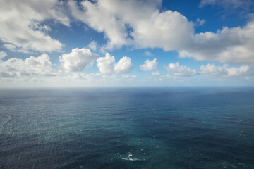 Panoramic aerial view of the deep blue Atlantic Ocean under a bright cloudy sky © ValentinValkov