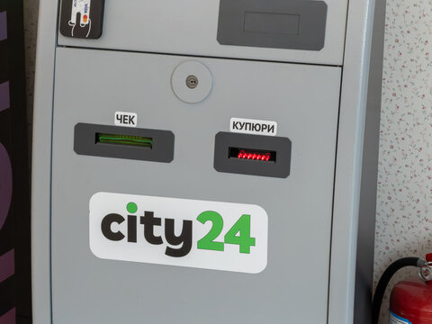 Kyiv, Ukraine - March 20, 2026: A City24 payment terminal with a card reader, receipt printer, and cash acceptor for secure automated financial transactions in busy public areas