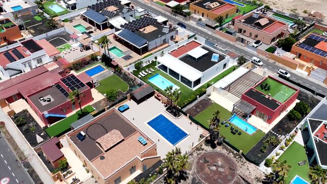 Aerial view of luxury expatriate villas with private swimming pools and real estate development in Caleta de Fuste