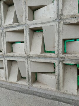 Modern geometric concrete roster wall with breeze blocks pattern