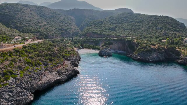 Aerial Drone Flight Toward Hidden Rocky Cove and Turquoise Sea Between Mountains in Coastal Mani Peninsula, Peloponnese, Greece
