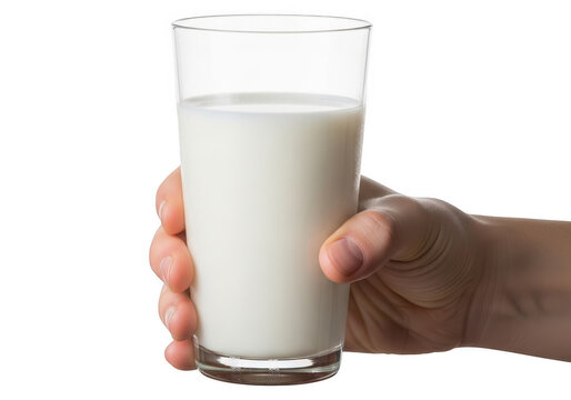 A hand holding a clear glass filled with fresh cold white milk drink isolated on transparent background