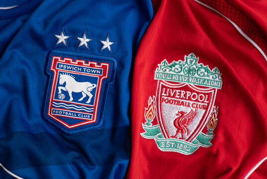 Kyiv, Ukraine. May 21, 2026. Close-up of Ipswich Town and Liverpool football club crests on jerseys side by side, sports rivalry concept.
