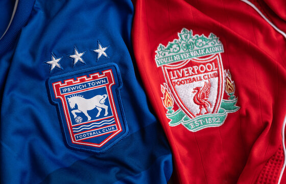 Kyiv, Ukraine. May 21, 2026. Close-up of Ipswich Town and Liverpool football club crests on jerseys side by side, sports rivalry concept.