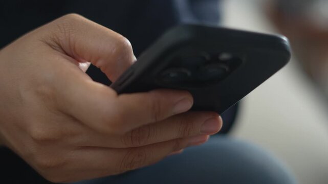 A woman uses a phone to edit a video.	
