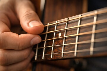 Fototapeta premium Close-up of Hands Playing Guitar Strings and Frets Music Performance and Hobby Concept