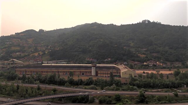 Drone aerial view of mountain houses and industrial valley near La Pena Asturias