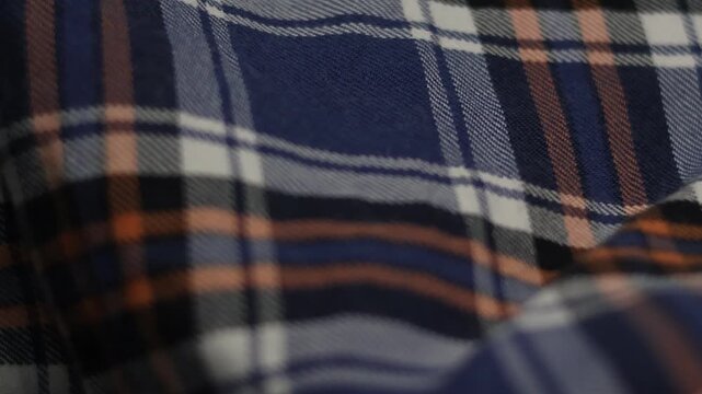 Close-up blue and orange plaid flannel fabric texture with soft focus