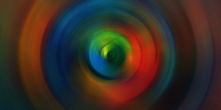 Colorful circular motion blur background with vibrant rainbow spectrum creating dynamic spin effect for creative abstract design.