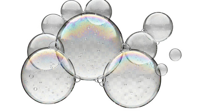 A cluster of transparent soap bubbles with iridescent rainbow reflections and tiny internal air droplets isolated on a solid black background