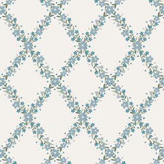 Elegant seamless floral trellis pattern with blue forget-me-not flowers and sage green leaves forming ogee diamond lattice on cream background. Perfect for fabric, wallpaper, textile and home decor. © Natalya