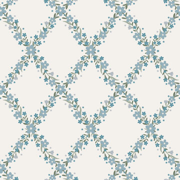 Elegant seamless floral trellis pattern with blue forget-me-not flowers and sage green leaves forming ogee diamond lattice on cream background. Perfect for fabric, wallpaper, textile and home decor.