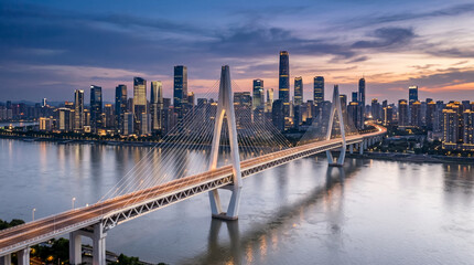 Fototapeta premium White cable stayed bridge sweeping across a silver river with sleek urban towers behind modern infrastructure