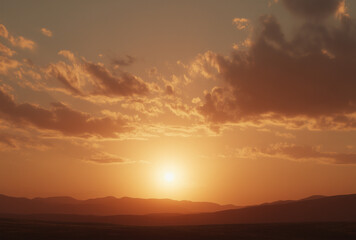 Fototapeta premium a sunset over mountainous terrain
