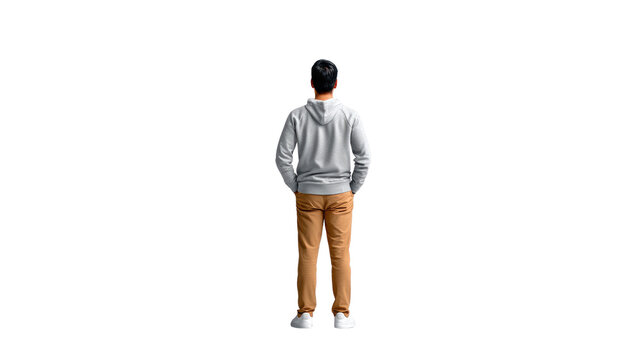 Man Standing Looking Ahead: A young man stands with his back to the camera, hands in his pockets, gazing into the distance, symbolizing contemplation and anticipation.