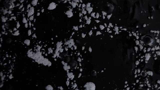 Tiny Ripples In Dark Liquid. Highdetail Image Showing Delicate Waves And Shiny Water Droplets