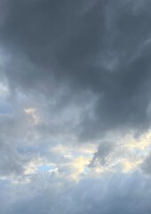 Fototapeta premium Dark dramatic storm clouds with sunlight in the sky