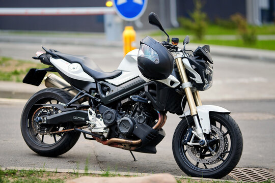 Minsk, Belarus. May 6, 2026. Powerful BMW F800R street motorcycle with Brembo disc brakes and exposed mechanical parts. Contemporary white sports motorbike standing parked on an asphalt parking lot
