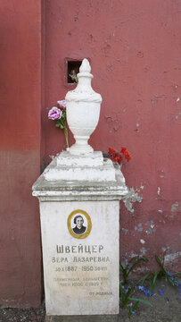 Moscow. Russia.The grave of Vera Lazarevna Schweitzer,a pioneer of the Bolshevik movement, with a vase on a pedestal and a portrait on the background of the wall of the Novodevichy Monastery