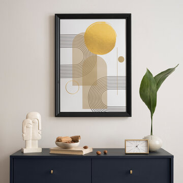 Stylish living room interior with abstract artwork, decorative elements, and a dark blue commode