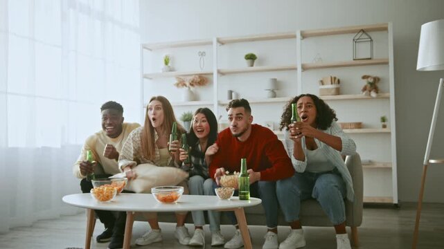 Five friends sit together on a couch in a bright living room, watching a movie. They hold drinks and snacks while reacting to the film.