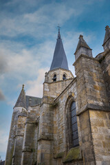 Fototapeta premium The Church of Notre-Dame de Puiseaux is an imposing 13th-century Gothic church, famous for its distinctive spiral spire and historical significance, France