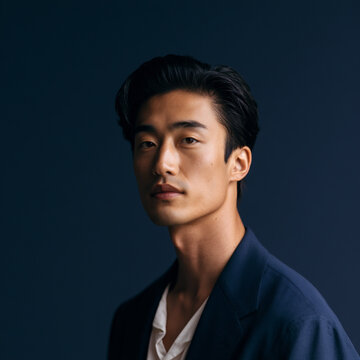 healthcare portrait with cinematic lighting, luxury clinic advertising concept with japanese male model, dark navy studio healthcare branding aesthetic