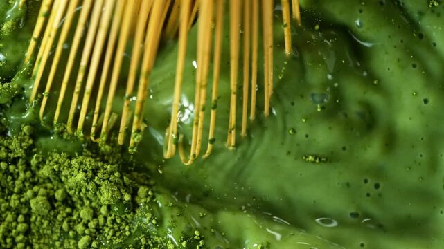 Bamboo Whisk Chasen Mixing Matcha Tea in Macro Close Up