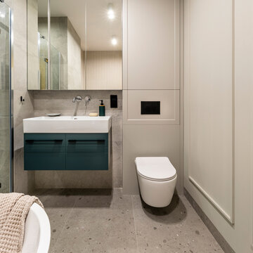 Modern Bathroom Interior with Floating Vanity, Vessel Sink, Wall-Mounted Toilet, and Tiled Floor in Minimalist Style