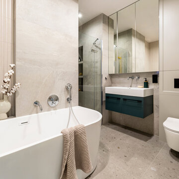 Modern light-filled bathroom with freestanding tub, sleek vanity, shower, toilet, and elegant decor for home design