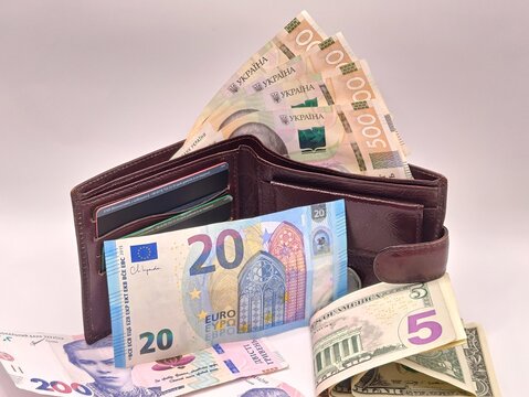 A wallet full of cash dollars and euros