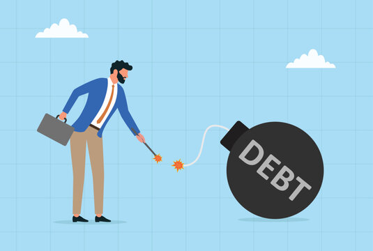 Businessman lighting the fuse of a debt bomb financial crisis concept
