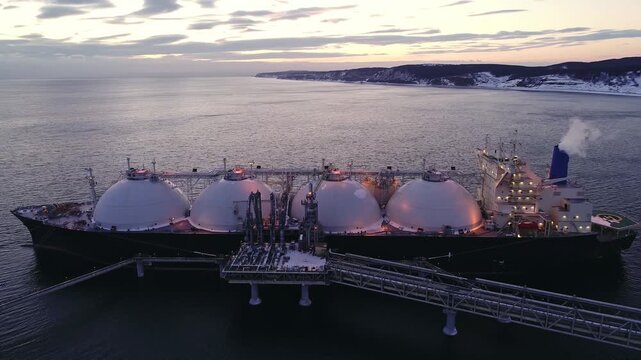 Aerial of Liquified Natural Gas LNG carrier moored to a small gas terminal. Fuel crisis. Sanctions