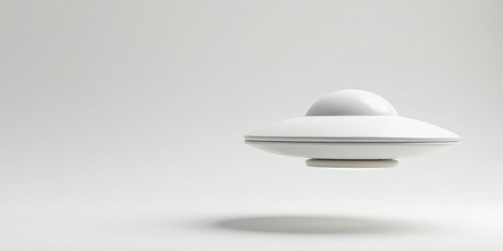 A Sleek White Unidentified Flying Object Hovering Gracefully Against a Plain White Background