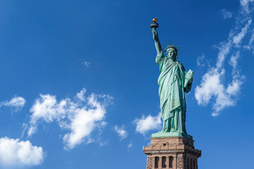 Fototapeta premium High angle view of the Statue of Liberty under blue sky with clouds in New York City, USA.
