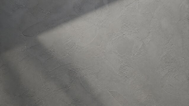 Grey concrete wall texture with soft light and shadow cast across the rough cement surface for design